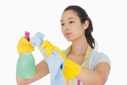 Technician performing carpet cleaning with equipment in a home interior