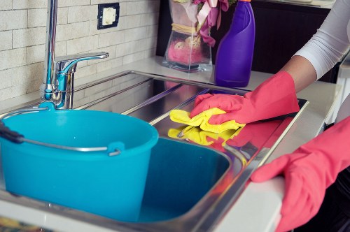Cleaner preparing a guest-ready short-term rental kitchen